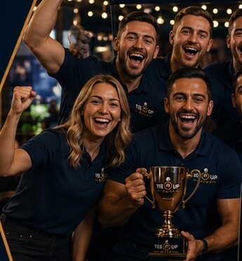 A winning pub team lifting their trophy as the room celebrates